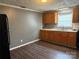 Kitchen with black refrigerator, hardwood floors, wooden cabinets, and a window at 303 Southern Ave, East Spencer, NC 28039