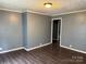 Neutral living room with hardwood floors, trim, and a doorway to another room at 303 Southern Ave, East Spencer, NC 28039
