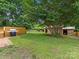 Spacious backyard with lush lawn, mature trees, and a shed area at 3042 Cresthill Dr, Charlotte, NC 28212