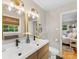 Elegant bathroom boasting a double sink vanity, a window with woven shades and a view to a bedroom at 3042 Cresthill Dr, Charlotte, NC 28212