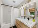 Bright bathroom featuring a double sink vanity, shower with white subway tile, and modern fixtures at 3042 Cresthill Dr, Charlotte, NC 28212