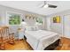 Cozy bedroom with hardwood floors, windows, and a ceiling fan at 3042 Cresthill Dr, Charlotte, NC 28212