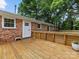 Wooden deck outside shows an open-air space for entertaining and relaxing, attached to a red brick house at 3042 Cresthill Dr, Charlotte, NC 28212