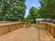 Outdoor wooden deck shows an open-air space for entertaining and relaxing, overlooking the lush green yard at 3042 Cresthill Dr, Charlotte, NC 28212