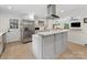 Bright kitchen featuring an island, stainless steel appliances, white countertops, and access to the backyard at 3042 Cresthill Dr, Charlotte, NC 28212