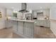 Modern kitchen with an island, stainless steel appliances, white countertops, and ample cabinetry at 3042 Cresthill Dr, Charlotte, NC 28212