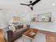 Open living room with hardwood floors, a comfortable sofa, and a pass-through to the modern kitchen at 3042 Cresthill Dr, Charlotte, NC 28212