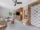 Living room features a brick wall, climbing holds, and a comfortable seating area at 3042 Cresthill Dr, Charlotte, NC 28212