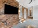 Living room with brick wall and modern entertainment setup at 3042 Cresthill Dr, Charlotte, NC 28212