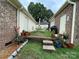 Backyard with brick sheds, table with chairs, and potted plants on green grass at 311 Tiffany Nw St, Concord, NC 28027
