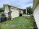 Backyard brick shed with white doors, a table and a grill on green grass at 311 Tiffany Nw St, Concord, NC 28027