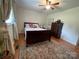 Bedroom featuring wood floors, a ceiling fan, an area rug, and natural light from one window at 311 Tiffany Nw St, Concord, NC 28027