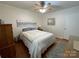Bedroom with ceiling fan, gray and white decor, and bright natural light from the window at 311 Tiffany Nw St, Concord, NC 28027