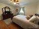 Bedroom with wood floors, an area rug, bright natural light, and a ceiling fan at 311 Tiffany Nw St, Concord, NC 28027