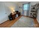 Bedroom featuring wood floors, a natural light window, and a gray area rug at 311 Tiffany Nw St, Concord, NC 28027
