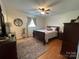 Bedroom features wood floors, a ceiling fan, an area rug, and natural light from one window at 311 Tiffany Nw St, Concord, NC 28027