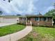 Charming brick home with a well-manicured lawn and a welcoming walkway at 311 Tiffany Nw St, Concord, NC 28027