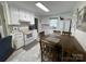 Efficient kitchen with white cabinets, a tile floor, and a dining table perfect for casual meals at 311 Tiffany Nw St, Concord, NC 28027