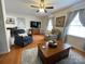 Comfortable living room with hardwood floors, a ceiling fan, and stylish furniture arrangement at 311 Tiffany Nw St, Concord, NC 28027