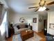 Well-lit living room with hardwood floors, a ceiling fan, and a comfortable sofa and chairs at 311 Tiffany Nw St, Concord, NC 28027
