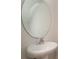 Modern powder room featuring a pedestal sink and oval mirror at 3349 Ellingford Rd, Charlotte, NC 28214