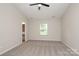 Spacious bedroom features neutral carpet, ceiling fan, and natural light from the window at 3349 Ellingford Rd, Charlotte, NC 28214