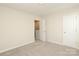 Neutral bedroom features a doorway and a closet door at 3349 Ellingford Rd, Charlotte, NC 28214
