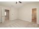 Neutral bedroom with plush carpet, ceiling fan, and access to other rooms at 3349 Ellingford Rd, Charlotte, NC 28214