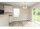 Bright dining area has a sliding glass door and a modern chandelier at 3349 Ellingford Rd, Charlotte, NC 28214
