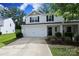 Two-story home with a white exterior, black shutters, an attached garage, and a well-manicured front lawn at 3349 Ellingford Rd, Charlotte, NC 28214