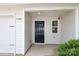 Close-up of the front door with a black door and white trim around the door and siding at 3349 Ellingford Rd, Charlotte, NC 28214