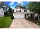 Traditional two-story home with a two-car garage, concrete driveway, and dark shutters at 3349 Ellingford Rd, Charlotte, NC 28214