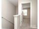 Hallway featuring carpeted stairs and a bedroom door at 3349 Ellingford Rd, Charlotte, NC 28214