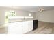 Stylish kitchen island with sink and dishwasher flows into the living space at 3349 Ellingford Rd, Charlotte, NC 28214