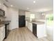 Open-concept kitchen with granite counters and black appliances for a modern feel at 3349 Ellingford Rd, Charlotte, NC 28214