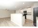 An open kitchen with sleek black appliances and an island that is perfect for entertaining at 3349 Ellingford Rd, Charlotte, NC 28214