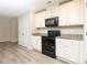 Modern kitchen features black appliances, granite counters, and white cabinets at 3349 Ellingford Rd, Charlotte, NC 28214