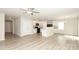 Open living space with modern flooring, light-colored walls, ceiling fan and open to the kitchen at 3349 Ellingford Rd, Charlotte, NC 28214