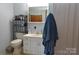 Bathroom featuring a toilet, sink, and shelf, with a blue towel hanging on the side at 3505 Valley Dr, Chester, SC 29706
