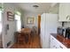 Eat-in kitchen with wood table and chairs, white refrigerator, and wood-look vinyl flooring at 3505 Valley Dr, Chester, SC 29706