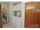 Laundry room with white washer and dryer, tile flooring, and doorway leading to a bedroom at 3505 Valley Dr, Chester, SC 29706