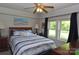 Bright bedroom featuring a blue striped bed, ceiling fan, and two windows with a view of the outdoors at 3505 Valley Dr, Chester, SC 29706