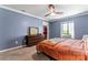 Relaxing bedroom featuring a comfortable bed, modern dresser, and bright window with plantation shutters at 3520 Colony Rd # D, Charlotte, NC 28211