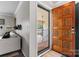 Inviting front door with decorative carved panels visible from the neutral-toned living room at 3520 Colony Rd # D, Charlotte, NC 28211
