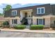 Charming townhome featuring classic brick facade, covered balconies, and well-manicured landscaping at 3520 Colony Rd # D, Charlotte, NC 28211
