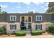 Charming townhome featuring classic brick facade, covered balconies, and well-manicured landscaping at 3520 Colony Rd # D, Charlotte, NC 28211