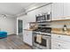 Kitchen with stainless steel range oven, granite countertops, and view of the dining room at 3520 Colony Rd # D, Charlotte, NC 28211