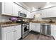 Well-lit kitchen with stainless steel appliances, granite countertops, and white cabinets at 3520 Colony Rd # D, Charlotte, NC 28211