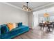 Cozy living room with a blue velvet sofa, modern lighting, and hardwood floors at 3520 Colony Rd # D, Charlotte, NC 28211