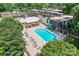 Aerial view of a pristine community pool surrounded by lounge chairs, perfect for relaxation and summer fun at 3520 Colony Rd # D, Charlotte, NC 28211